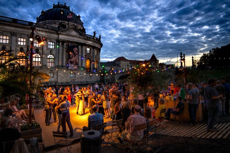 Evening dance event at Bode Museum in Berlin with vibrant lights and joyful participants.