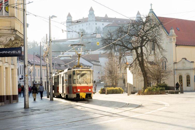 Tram in old town Bratislava with historical buildings in the background.
