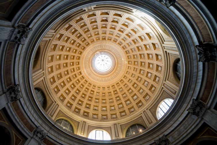 Ornate dome interior of a historic building in Vatican City with intricate details.