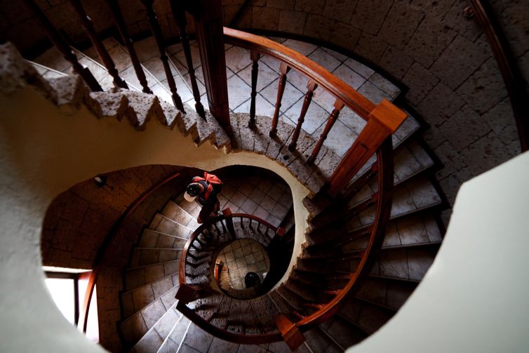 Spiral staircase in Brașov, Romania, displaying intricate architectural design and textures.
