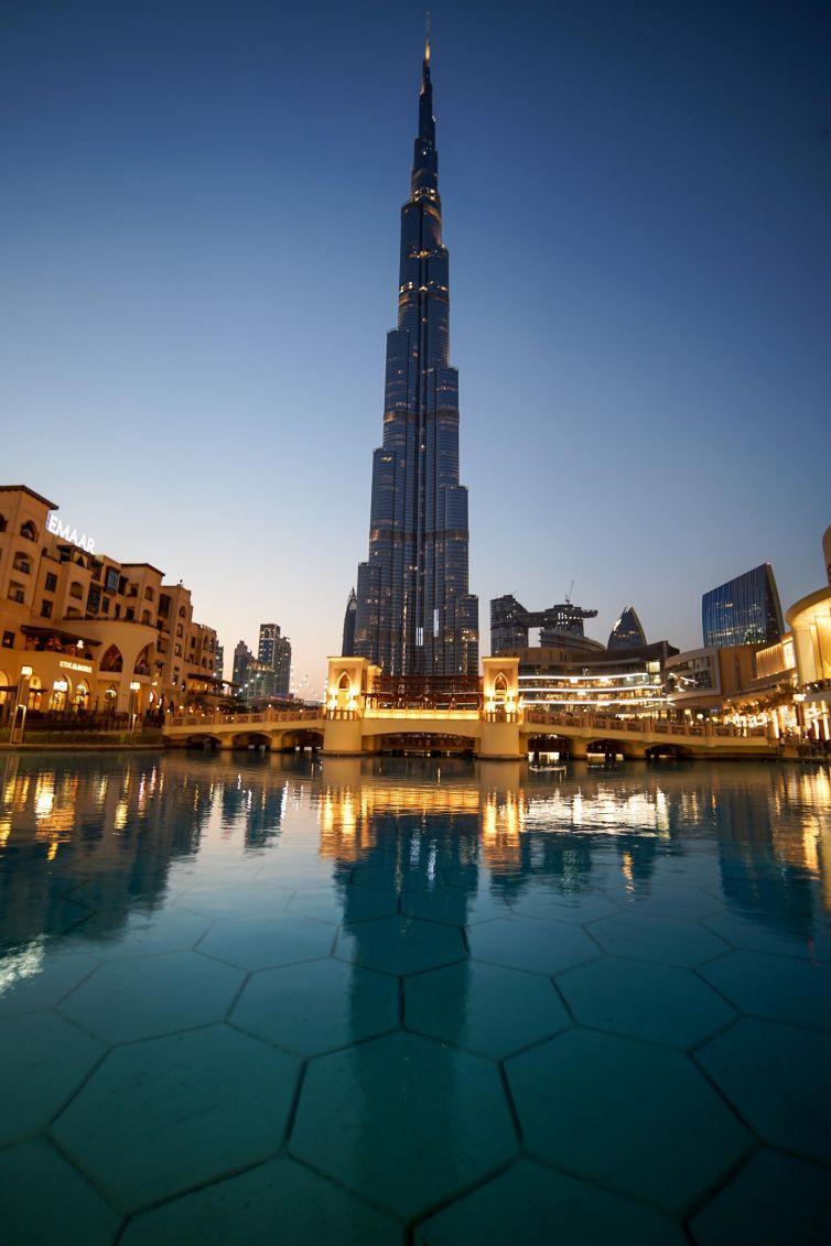 Reflective view of Burj Khalifa against a twilight sky in Dubai.