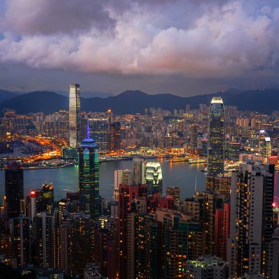 Vibrant twilight skyline of Hong Kong showcasing modern architecture and serene waters.