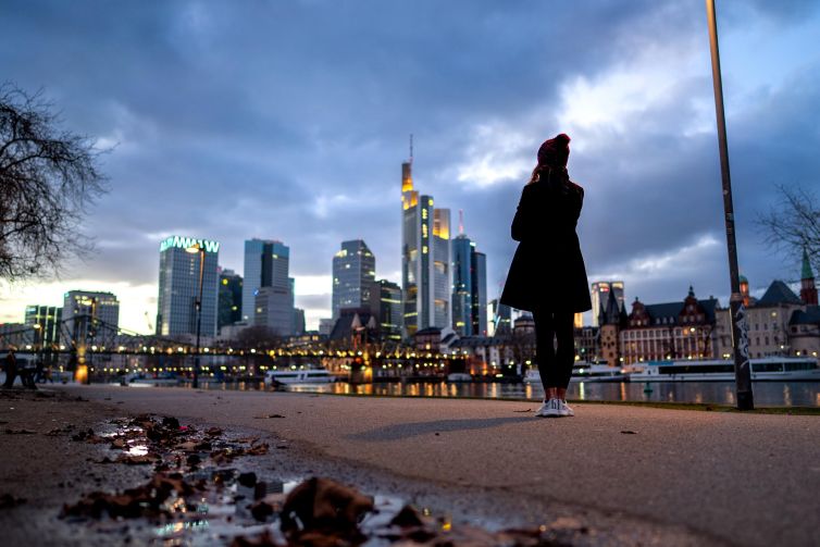 Evening view of Frankfurt skyline with reflections in the river.