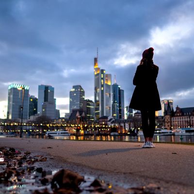 Evening view of Frankfurt skyline with reflections in the river.
