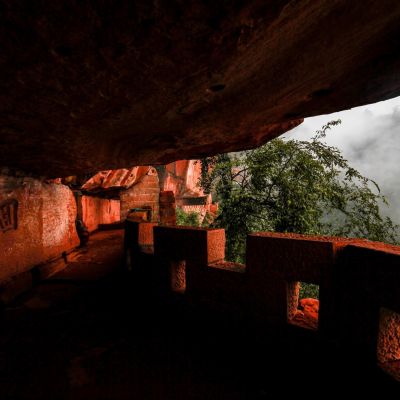 Misty view of rock formations and ancient shrines in Yibin, Sichuan, China.