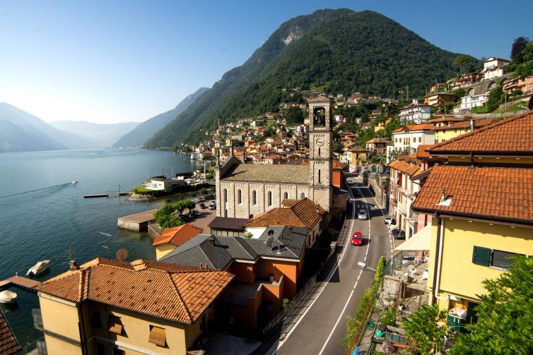 Scenic landscape of Argegno village by Lake Como, Italy, featuring lush mountains and traditional architecture.