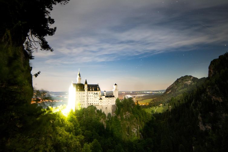 Neuschwanstein Castle illuminated at night in Bavaria, Germany.
