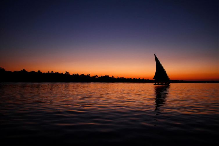 Faluca sailing on the Nile River at sunset