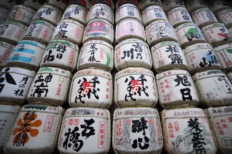Sake barrels in Tokyo showcasing traditional Japanese art and calligraphy.