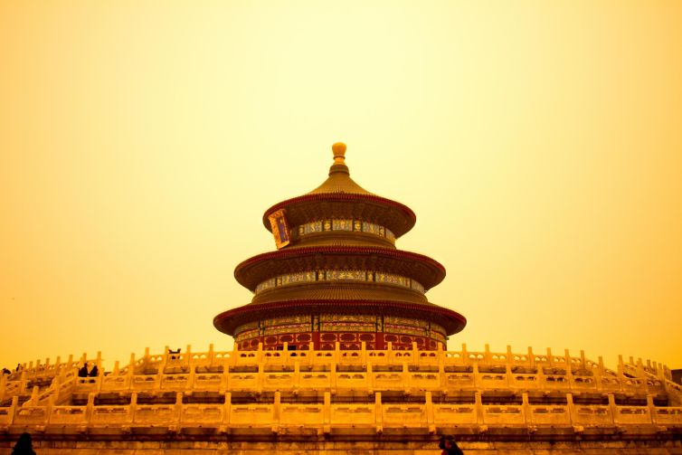 Temple of Heaven in Beijing, showcasing intricate architecture against a sandstone sky.