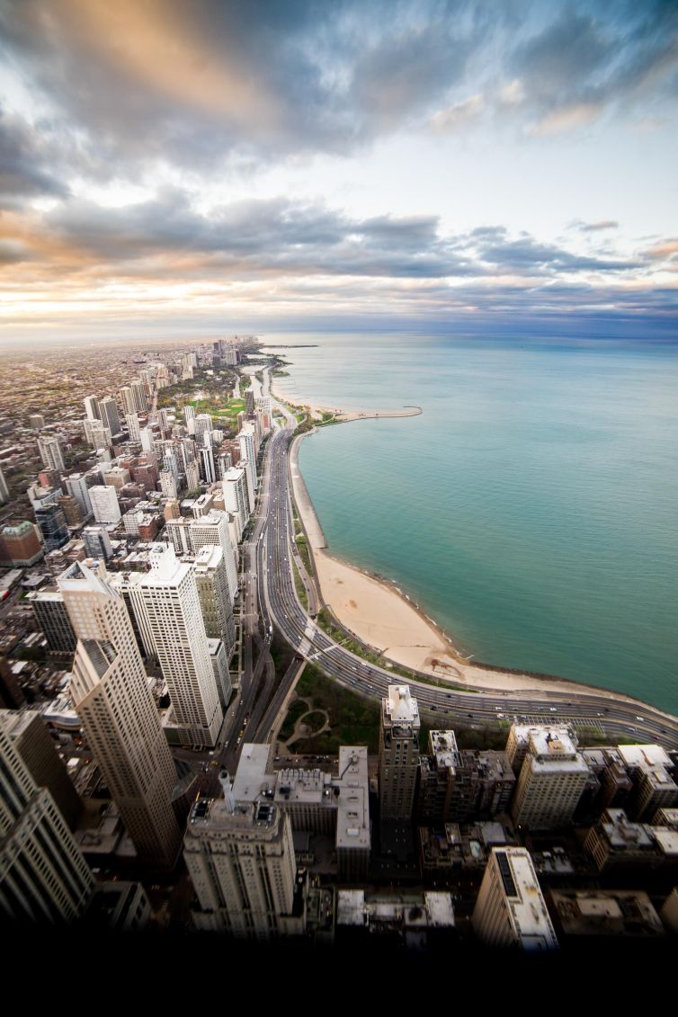 Aerial view of Chicago's coastline from the Hancock Center, featuring the beach and city skyline.