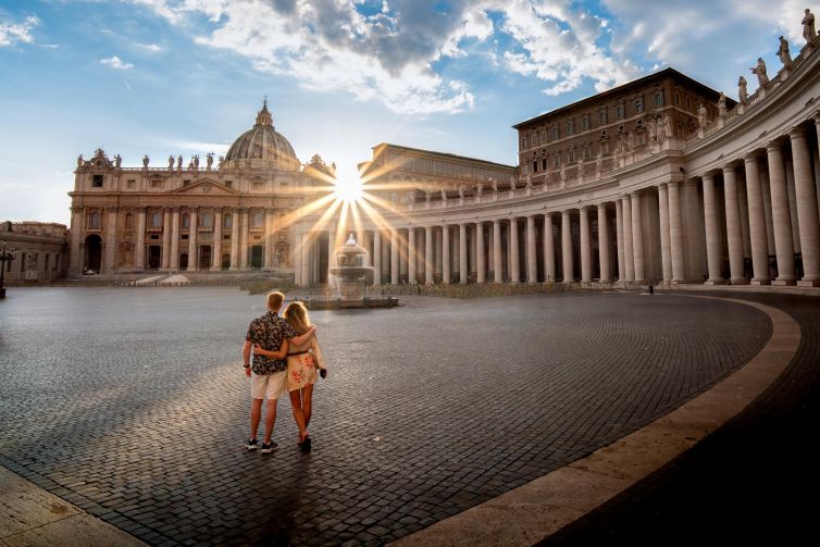 Couple embracing at sunset in St. Peter's Basilica, Vatican City.