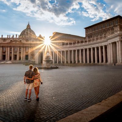 Couple embracing at sunset in St. Peter's Basilica, Vatican City.