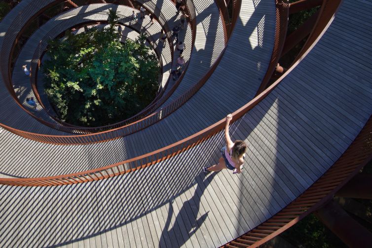 Spiral walkway surrounded by trees in Rønnede, Denmark, showcasing modern architecture.