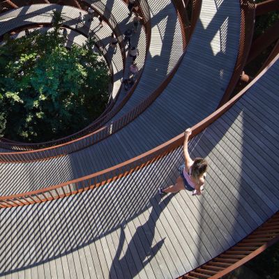 Spiral walkway surrounded by trees in Rønnede, Denmark, showcasing modern architecture.